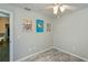 A simple bedroom features artwork and wood-look vinyl flooring at 3175 Lakatos St, North Port, FL 34286