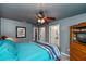 Bedroom with cool-toned walls featuring a ceiling fan, two closets, and a door to the bathroom at 3175 Lakatos St, North Port, FL 34286
