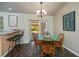 Bright dining area featuring a round table with seating for four and bar top seating at 3175 Lakatos St, North Port, FL 34286