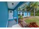 Covered front porch with colorful landscaping and a welcoming front door, offering curb appeal at 3175 Lakatos St, North Port, FL 34286