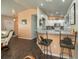 Cozy kitchen with bar seating and modern appliances with an adjacent living area at 3175 Lakatos St, North Port, FL 34286