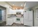 Bright kitchen with white cabinets, modern appliances, and ample countertop space at 3175 Lakatos St, North Port, FL 34286