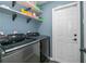 Laundry room with new washer and dryer with lots of space and shelving at 3175 Lakatos St, North Port, FL 34286