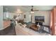 Open living space with tile flooring, ceiling fan, and a large television for entertainment at 3175 Lakatos St, North Port, FL 34286