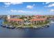 Aerial view of the condo complex highlighting water access, boat docks, and a community pool at 3334 Purple Martin Dr # 214, Punta Gorda, FL 33950