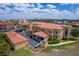 Aerial view showcases building's architectural style, parking facilities, green spaces, and landscaping at 3334 Purple Martin Dr # 214, Punta Gorda, FL 33950