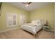 Comfortable bedroom with soft lighting and two windows adorned with shutters at 3334 Purple Martin Dr # 214, Punta Gorda, FL 33950