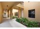 Exterior hallway featuring neutral colored stucco, garden area, lighting, and access to units at 3334 Purple Martin Dr # 214, Punta Gorda, FL 33950