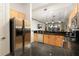 Modern kitchen with stainless steel refrigerator, granite countertops, and stylish pendant lighting at 3334 Purple Martin Dr # 214, Punta Gorda, FL 33950
