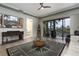 Living room with tile floors, ceiling fan, entertainment center, and sliding doors to a porch at 3334 Purple Martin Dr # 214, Punta Gorda, FL 33950