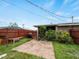 Backyard with a paver patio, wood fence, and mature trees at 3561 Middletown St, Port Charlotte, FL 33952