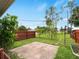 Backyard with a paver patio, wood fence, and mature trees at 3561 Middletown St, Port Charlotte, FL 33952