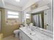 Bathroom featuring vanity with a large mirror, ample lighting, and fixtures at 3561 Middletown St, Port Charlotte, FL 33952