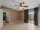 Bedroom featuring tile floors, a ceiling fan, and sliding glass door at 3561 Middletown St, Port Charlotte, FL 33952