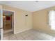 Comfortable bedroom featuring neutral tones, tile flooring, natural light, and convenient access to hallway at 3561 Middletown St, Port Charlotte, FL 33952