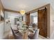 Bright dining room features modern lighting, glass table and gray upholstered chairs at 3561 Middletown St, Port Charlotte, FL 33952