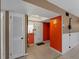 Entryway featuring an orange accent wall, light tile, and a white entry door at 3561 Middletown St, Port Charlotte, FL 33952