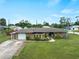 Charming single-story home with a well-maintained lawn and inviting curb appeal on a sunny day at 3561 Middletown St, Port Charlotte, FL 33952