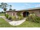 Inviting front entrance with a beautifully landscaped walkway leading to the front door at 3561 Middletown St, Port Charlotte, FL 33952