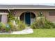 Charming front door with decorative landscaping and a small fountain at 3561 Middletown St, Port Charlotte, FL 33952