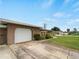 Spacious one car garage featuring a paved driveway and tidy landscaping at 3561 Middletown St, Port Charlotte, FL 33952