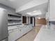 Stylish kitchen equipped with stainless steel refrigerator, open shelving, and a seamless view into the living area at 3561 Middletown St, Port Charlotte, FL 33952