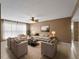 Spacious living room offers plush seating, neutral color palette and a ceiling fan at 3561 Middletown St, Port Charlotte, FL 33952