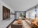 Comfortable living room with white shiplap wall, modern lighting, and bright natural light at 3561 Middletown St, Port Charlotte, FL 33952