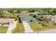 Aerial view of a home with lush landscaping, and a large driveway at 4260 Kessler Ter, North Port, FL 34287