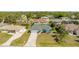 Aerial view of a home with lush landscaping, and a long driveway at 4260 Kessler Ter, North Port, FL 34287
