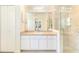 Bathroom featuring a sink, mirror, glass door shower, and closet storage space at 4260 Kessler Ter, North Port, FL 34287