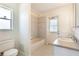 Well-lit bathroom with tub, shower, and sink at 4260 Kessler Ter, North Port, FL 34287