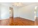 Bedroom with hardwood floors and doorways leading to the bathroom and closet at 4260 Kessler Ter, North Port, FL 34287