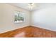 Bright bedroom featuring hardwood floors and a ceiling fan with an outdoor view at 4260 Kessler Ter, North Port, FL 34287