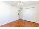 Bedroom featuring hardwood floors, closet, and ceiling fan with overhead lighting at 4260 Kessler Ter, North Port, FL 34287