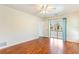 Bedroom with hardwood floors and access to enclosed outdoor patio through glass doors at 4260 Kessler Ter, North Port, FL 34287
