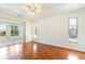 Bedroom with hardwood floors and sliding glass doors opening to the enclosed patio at 4260 Kessler Ter, North Port, FL 34287