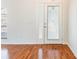 Bright entryway featuring wood floors, a front door with decorative glass, and white walls at 4260 Kessler Ter, North Port, FL 34287