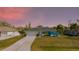 Inviting home with lush lawn, vibrant turquoise paint, and a spacious driveway at 4260 Kessler Ter, North Port, FL 34287