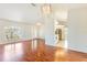 Open-concept living room featuring wood floors, white walls, and a view of the adjacent kitchen at 4260 Kessler Ter, North Port, FL 34287