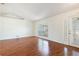 Inviting living room boasting wood floors, white walls, and a large window with natural light at 4260 Kessler Ter, North Port, FL 34287