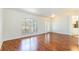Bright living room with wood floors, white walls, and a large window offering pleasant views at 4260 Kessler Ter, North Port, FL 34287