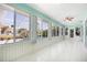 Bright sunroom featuring a ceiling fan, lots of windows, and tile flooring at 4260 Kessler Ter, North Port, FL 34287