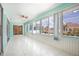 Sunroom with a ceiling fan, lots of windows, and tile flooring, with pool view at 4260 Kessler Ter, North Port, FL 34287