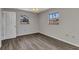 Cozy bedroom with wood floors, neutral walls, and natural light from two windows at 428 Briarwood Rd, Venice, FL 34293