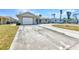 Single-story home featuring a wide driveway leading to an attached garage and well-maintained front yard at 428 Briarwood Rd, Venice, FL 34293