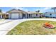 Charming single-story home with a well-manicured lawn and a driveway leading to the attached garage at 428 Briarwood Rd, Venice, FL 34293