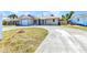 Charming one-story home with a curving driveway, front lawn, and an attached garage at 428 Briarwood Rd, Venice, FL 34293