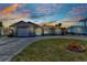 Charming single-story home with a well-manicured lawn and a driveway leading to the attached garage at 428 Briarwood Rd, Venice, FL 34293