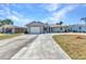 Charming one-story home with a curving driveway, front lawn, and an attached garage at 428 Briarwood Rd, Venice, FL 34293